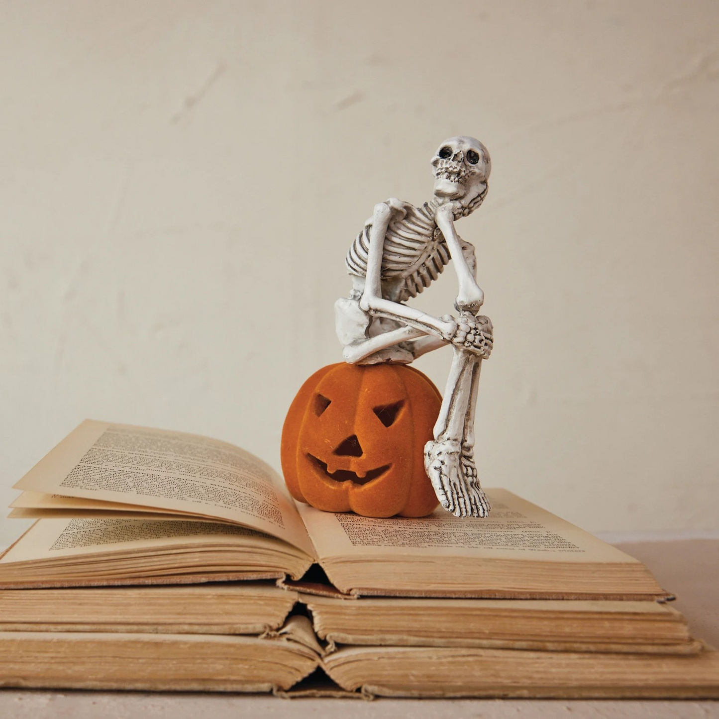 Resin Skeleton Sitting on Flocked Jack-O-Lantern