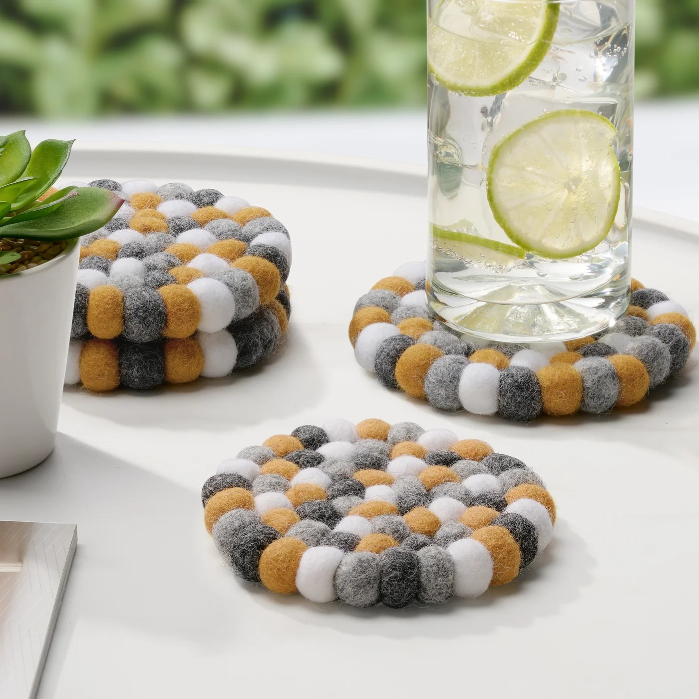 MODWOOL™ Felt Ball Four Piece Round 4" Diameter Coaster Set | Yellow/Grey/White